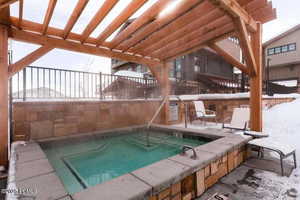 View of pool featuring a pergola, a patio, and a community hot tub