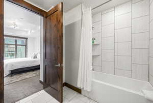 White tiled shower with built-in shelving and tub