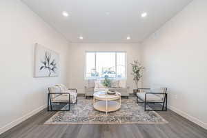 Sitting room featuring dark wood-type flooring and recessed lighting