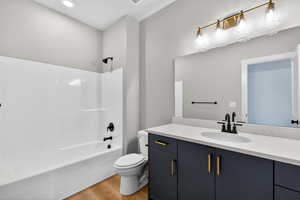 Full bathroom with vanity, shower / washtub combination, and light wood-type flooring