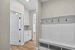 Mudroom with light wood-style flooring and recessed lighting