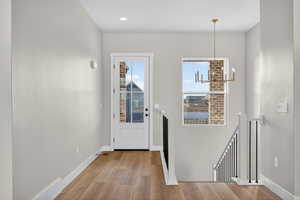 Entryway featuring a chandelier and light wood-type flooring