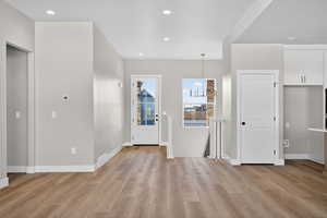Entryway featuring recessed lighting, light wood finished floors, and a chandelier