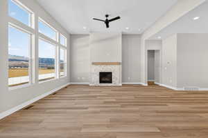 Unfurnished living room featuring light wood-style floors, a fireplace, recessed lighting, and a ceiling fan