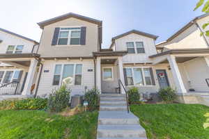 View of front of property with a front lawn and board and batten siding