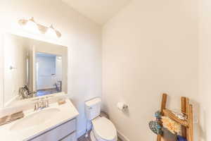 Half bath with vanity and toilet