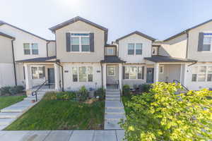 View of front of home featuring board and batten siding and a front yard
