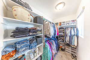 Walk in closet with carpet flooring