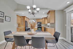 Dining room featuring a chandelier, light wood-style flooring, and recessed lighting