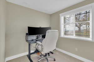Carpeted office with baseboards