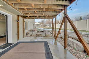Fenced backyard with a patio and a storage unit