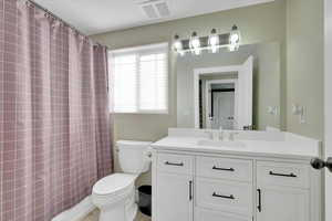 Full bath featuring vanity and a shower with shower curtain