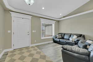 Living area with vaulted ceiling, light wood-type flooring, and recessed lighting