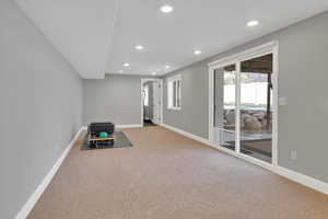 Unfurnished room with recessed lighting and light carpet