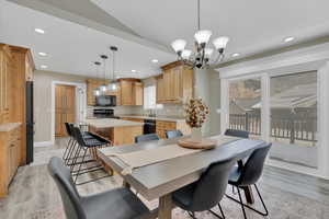 Dining room featuring recessed lighting, light wood-style floors, and a chandelier