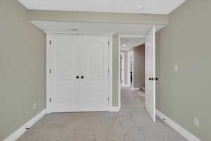 Unfurnished bedroom with carpet and a closet