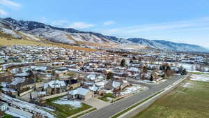 Snowy aerial view with a residential view and a mountain view