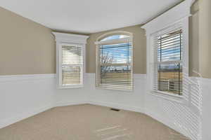 Empty room featuring light colored carpet
