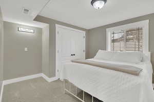 Bedroom with a closet and light carpet