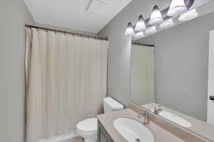 Bathroom featuring vanity and shower / tub combo with curtain
