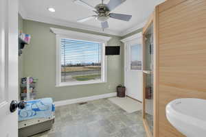 Full bathroom with a relaxing sauna, crown molding, stone finish flooring, a soaking tub, and recessed lighting