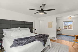 Bedroom with wood finished floors and a ceiling fan