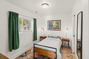 Bedroom featuring wood finished floors and baseboards