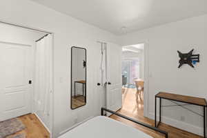 Bedroom featuring light wood-style flooring and a closet