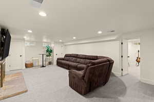 Living room with recessed lighting and light colored carpet