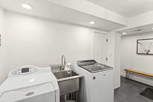 Laundry room with recessed lighting and independent washer and dryer