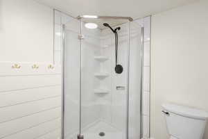 Bathroom with a stall shower and toilet