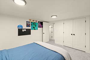 Carpeted bedroom with a closet
