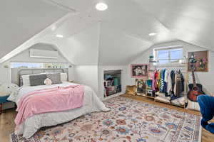 Bedroom with wood finished floors, recessed lighting, and a textured ceiling