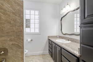 Bathroom featuring vanity and baseboards