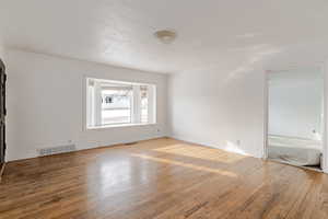 Spare room featuring light wood-style flooring