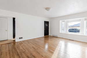 Empty room with light wood-style flooring and baseboards