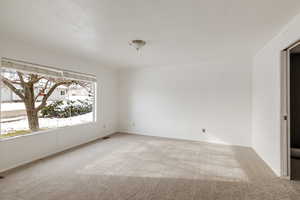 Empty room featuring light colored carpet