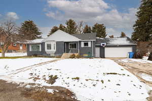 View of front of house featuring brick siding, an attached garage, and driveway