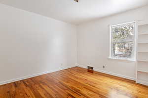 Spare room with light wood-style flooring and baseboards