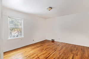 Empty room featuring light wood finished floors and baseboards