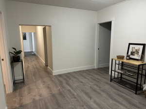 Corridor with wood finished floors and baseboards