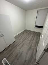 Unfurnished room featuring wood finished floors and baseboards