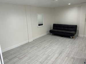 Living area with baseboards and wood finish floors