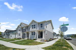 View of front facade with a residential view, board and batten siding, and a front yard