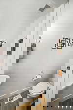 Bathroom featuring baseboards and wood finished floors