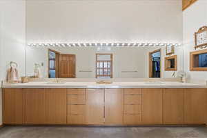 Bathroom featuring double vanity and dark colored carpet