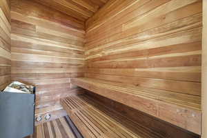 Sauna featuring wooden walls and wooden ceiling