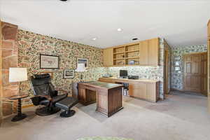Home office featuring wallpapered walls, light carpet, and recessed lighting