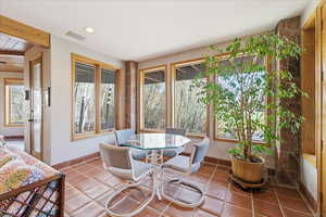 Dining space with tile patterned flooring and recessed lighting