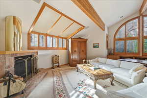 Living room featuring a glass covered fireplace and carpet